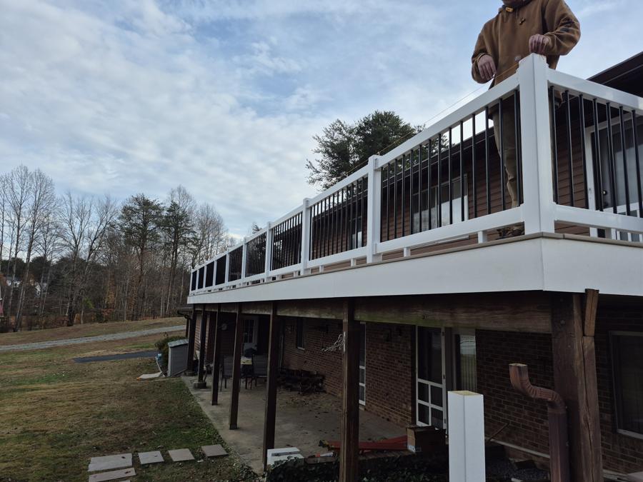 Second-story deck with white PVC fascia and railing
