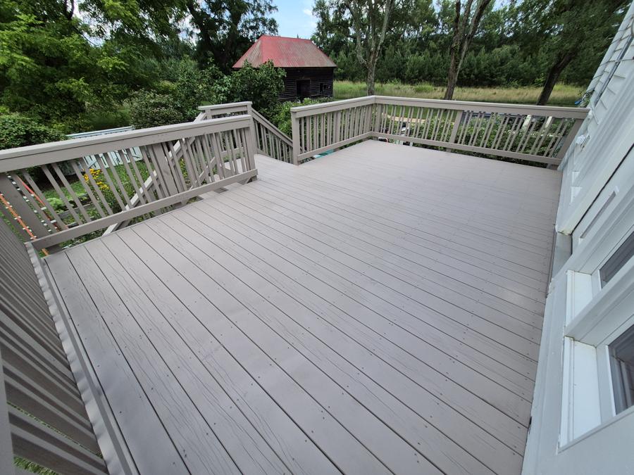 Restored and painted deck overlooking a barn