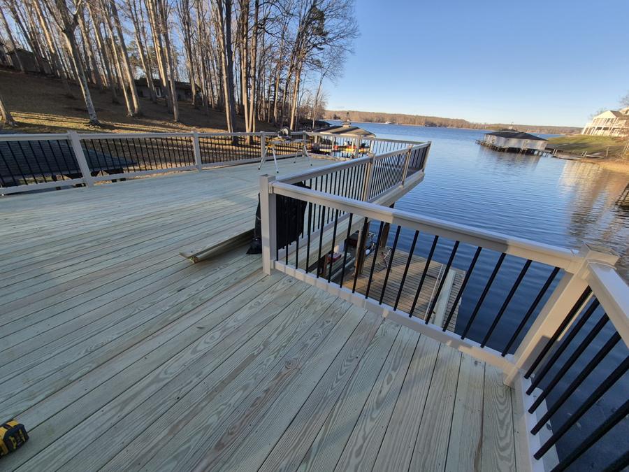 Lakefront deck with aluminum railing over a boathouse