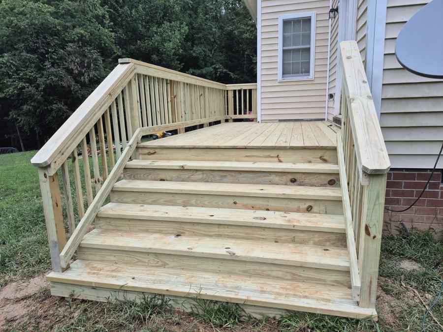 Wide pressure-treated steps up to a deck
